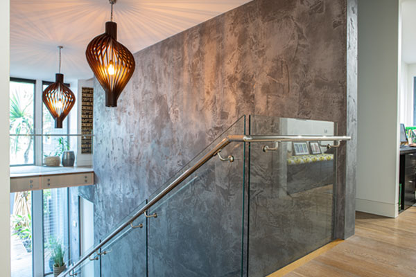 Tadelakt feature wall in dark grey, rough finish with water based polyurethane sealer.